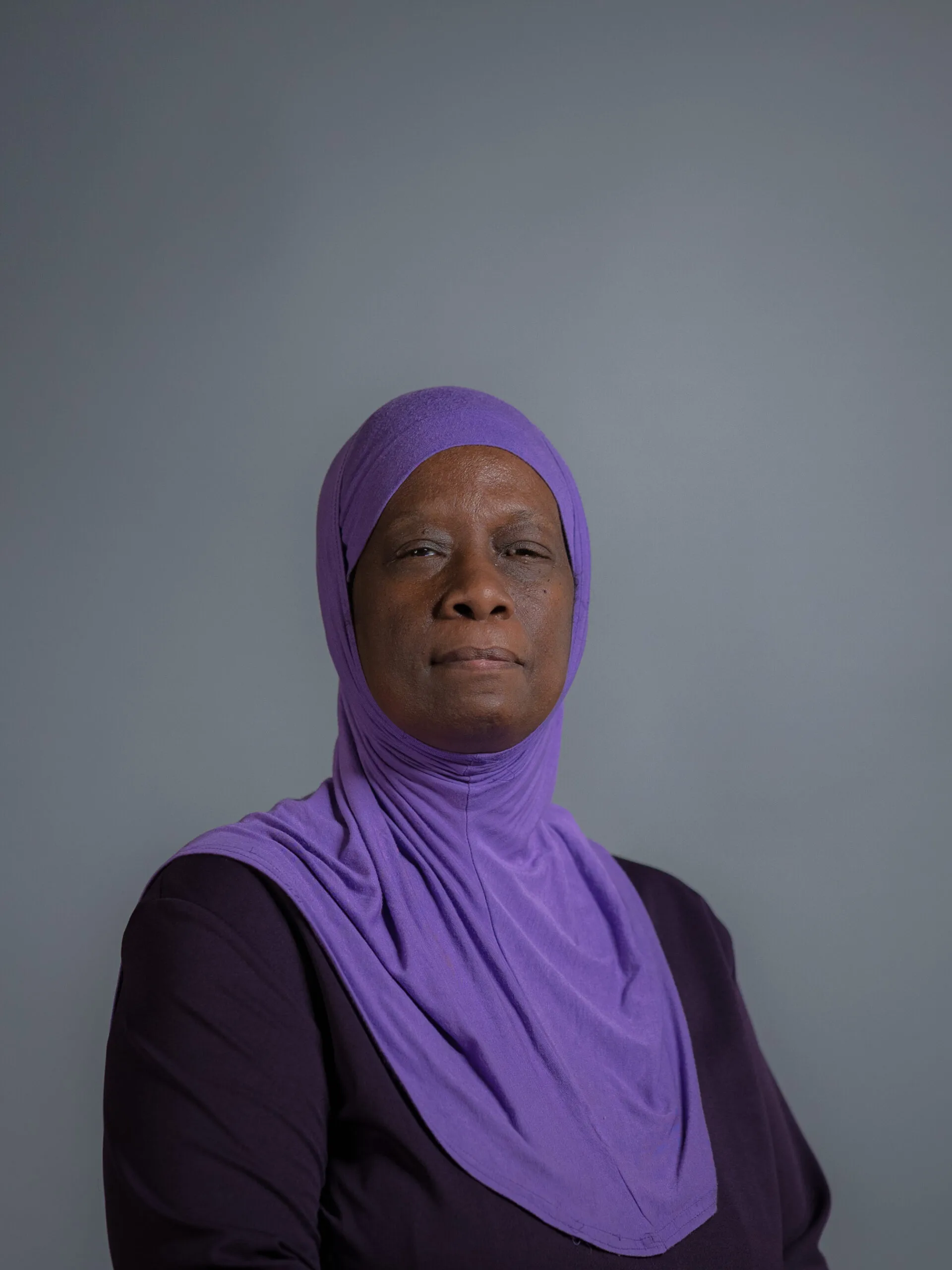 Professional headshot of Grindl Holmes for Arqam Academy