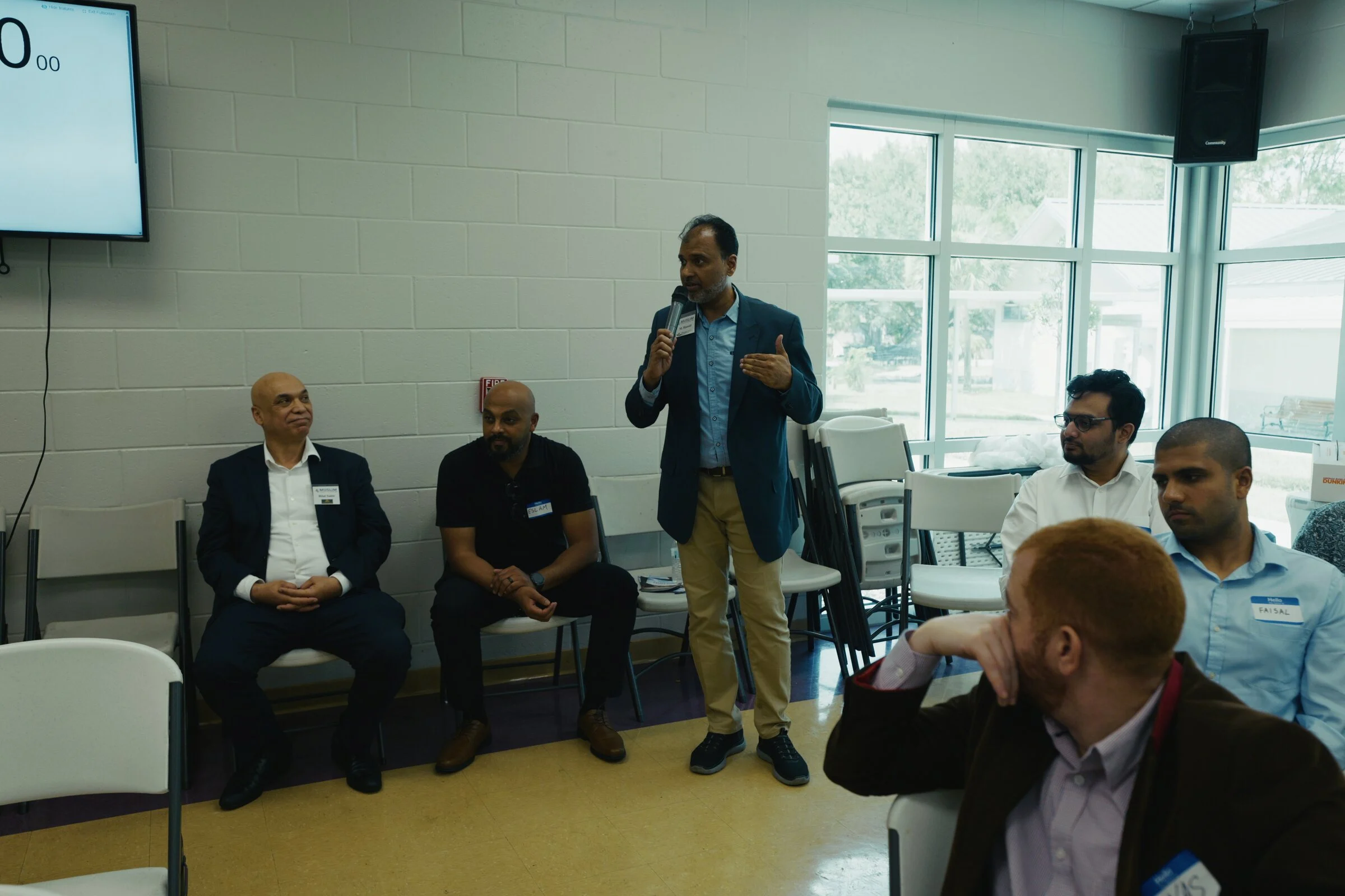 A presenter speaking to attendees during the Muslim Chamber of Commerce USA AI workshop